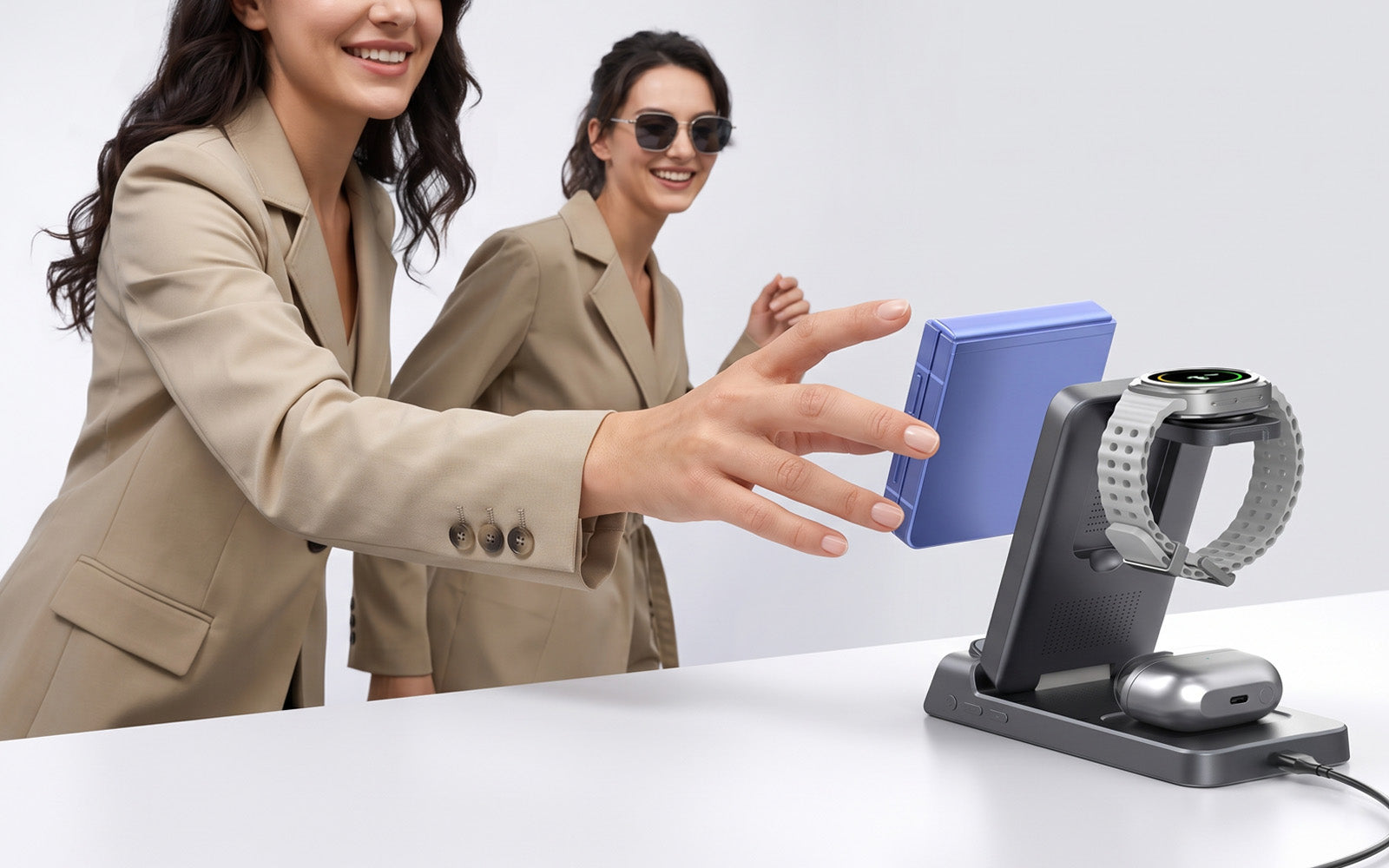 Business traveller holding the Elecdov CE20S foldable 25W Qi2 wireless charging station with phone, smartwatch and earbuds on a white table